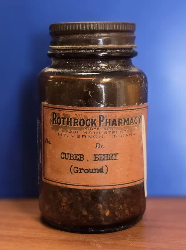 Vintage Rothrock Pharmacy bottle labeled “Cubeb Berry (Ground)” with visible ground botanical material.