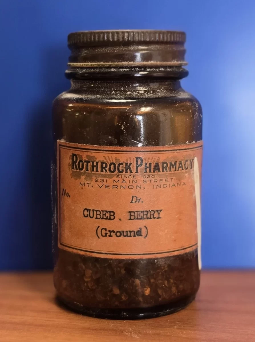Vintage Rothrock Pharmacy bottle labeled “Cubeb Berry (Ground)” with visible ground botanical material.