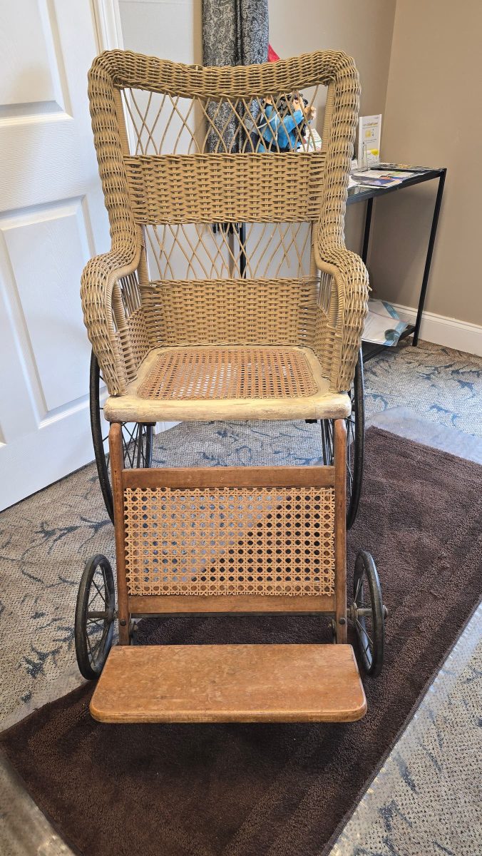 Antique wicker wheelchair on carpeted floor