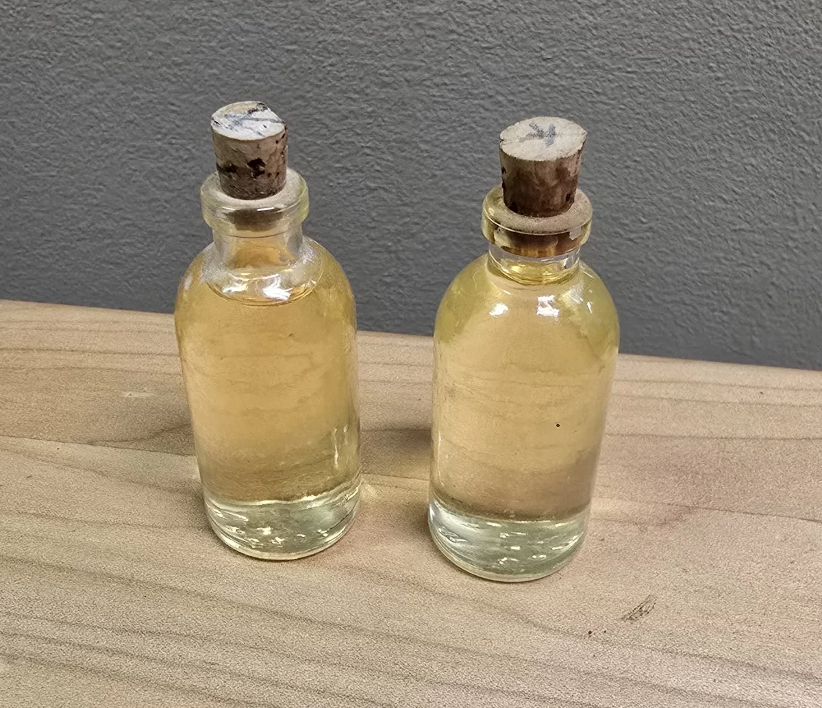 Vintage apothecary bottles with cork stoppers and preserved amber liquid
