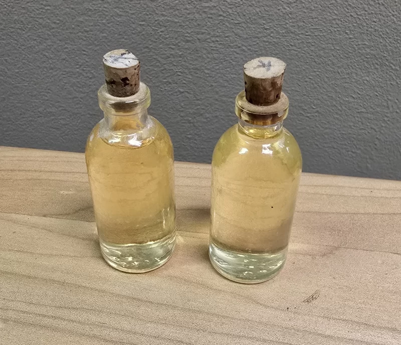 Vintage apothecary bottles with cork stoppers and preserved amber liquid