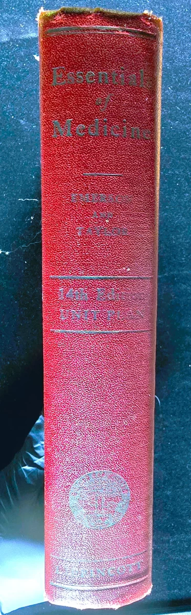 Spine of Essentials of Medicine hardcover, worn red cloth with gold lettering