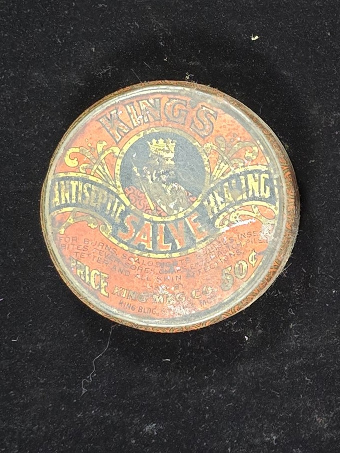 Front label of King’s Antiseptic Healing Salve tin featuring crowned king and product description