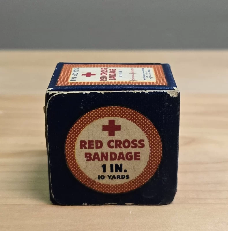 Vintage Johnson & Johnson Red Cross Bandage Box with 1-inch gauze roll and legal disclaimer