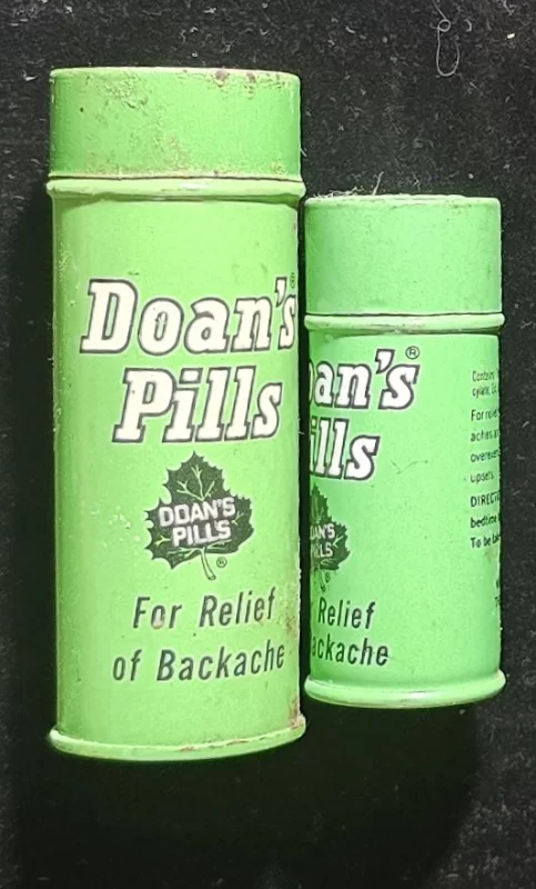 Vintage green metal tins of Doan’s Pills, labeled for backache relief—one 85-count, one 40-count