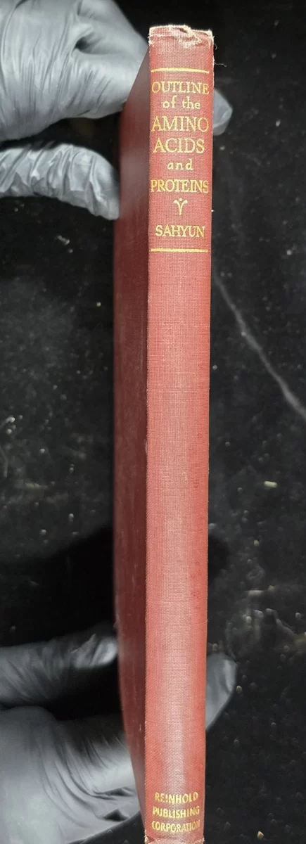 Spine of Outline of the Amino Acids and Proteins, showing title and publisher (Reinhold)