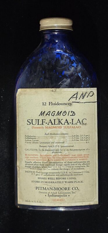 Vintage cobalt blue bottle labeled “Magmoid Sulf-Alka-Lac” by Pitman-Moore Co.