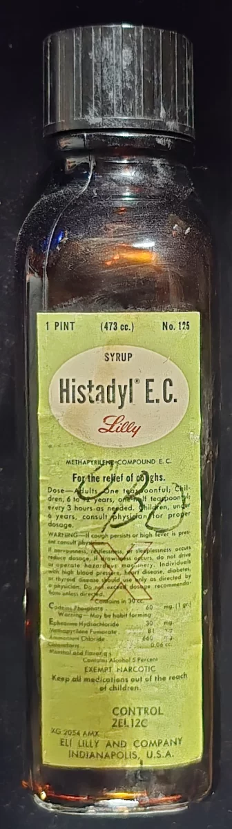 Vintage Histadyl E.C. cough syrup bottle with original label, showing ingredients and exempt narcotic classification.