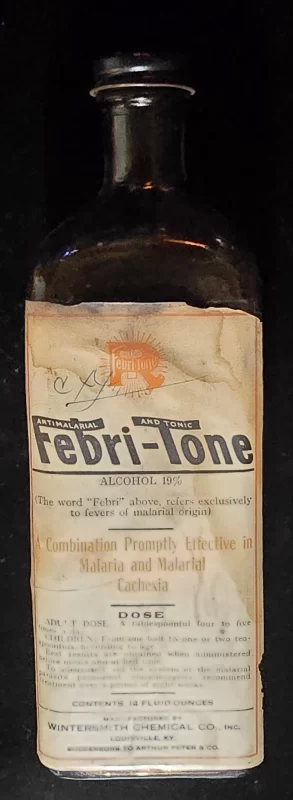 Vintage bottle labeled “Febri-Tone Antimalarial and Tonic,” produced by Wintersmith Chemical Co., Louisville, KY. Label claims effectiveness against malaria and malarial cachexia, with 19% alcohol content.
