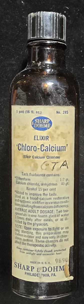 Vintage bottle labeled “Elixir Chloro-Calcium” by Sharp & Dohme, listing chloroform, calcium chloride, and 15% alcohol as ingredients. Used as a blood-calcium restorative in early 20th century medicine.