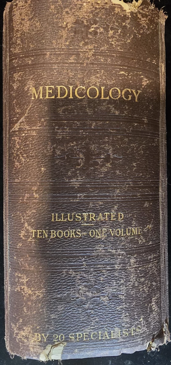 Cover of Medicology, embossed leather with gold lettering, worn edges