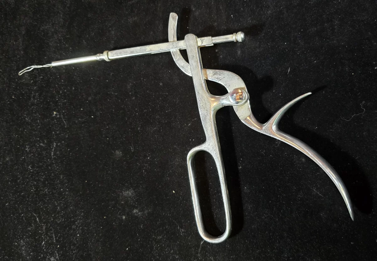 Vintage Sklar tonsil snare with wire loop and pistol grip, marked MD-USN, used in mid-20th century military surgeries