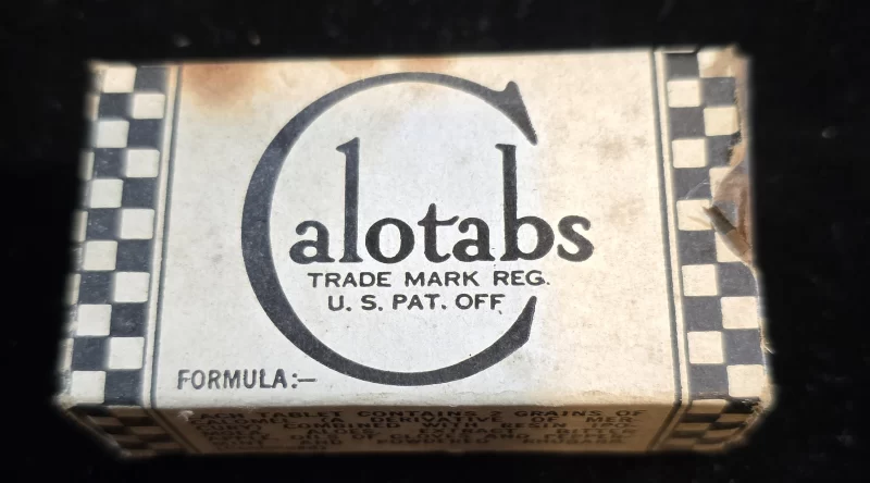 Vintage Calotabs box with checkerboard design and included mercury-based laxative tablets.