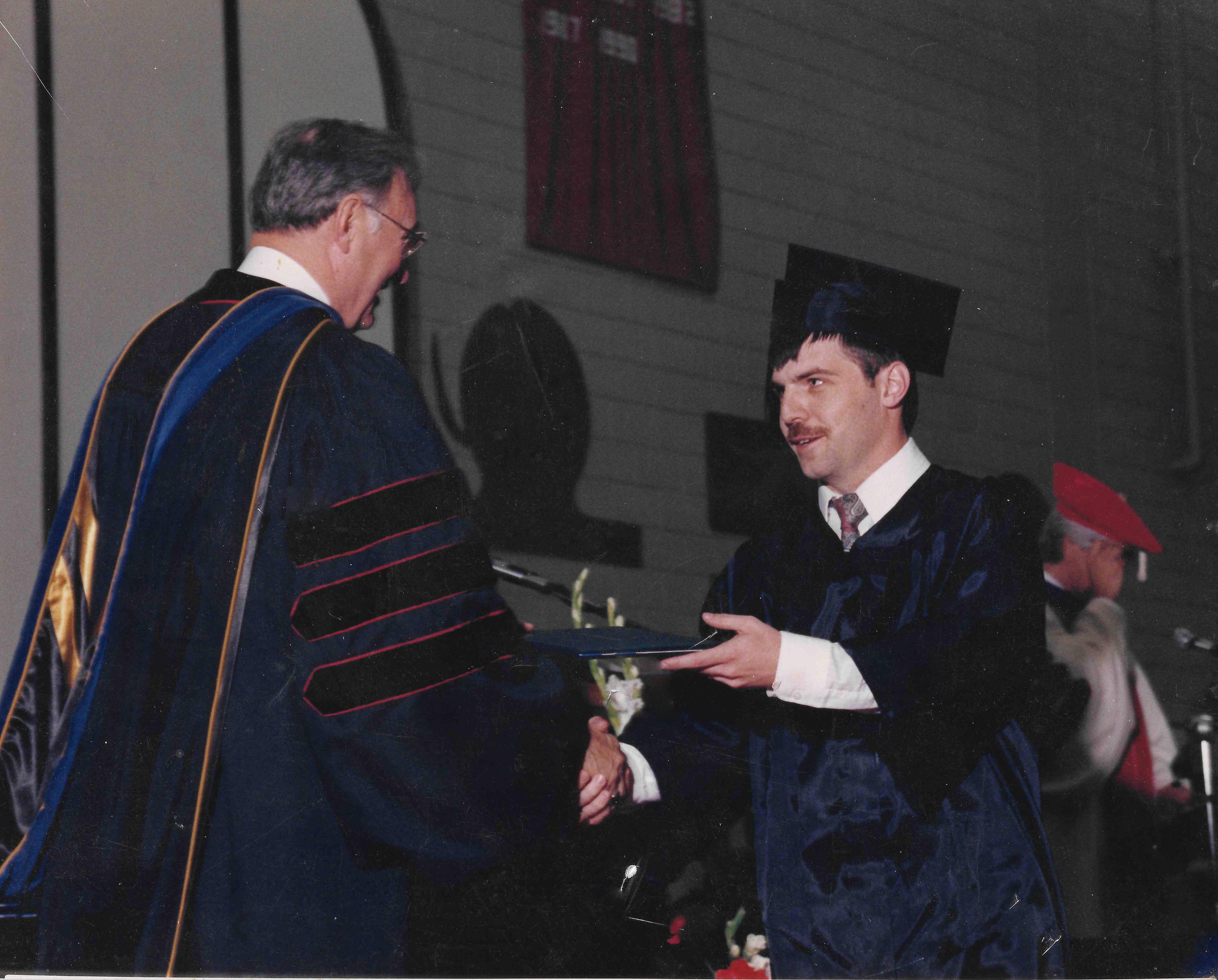 Dr. Bebout receiving diploma at IU School of Medicine graduation ceremony, 1995, RCA Dome Indianapolis.