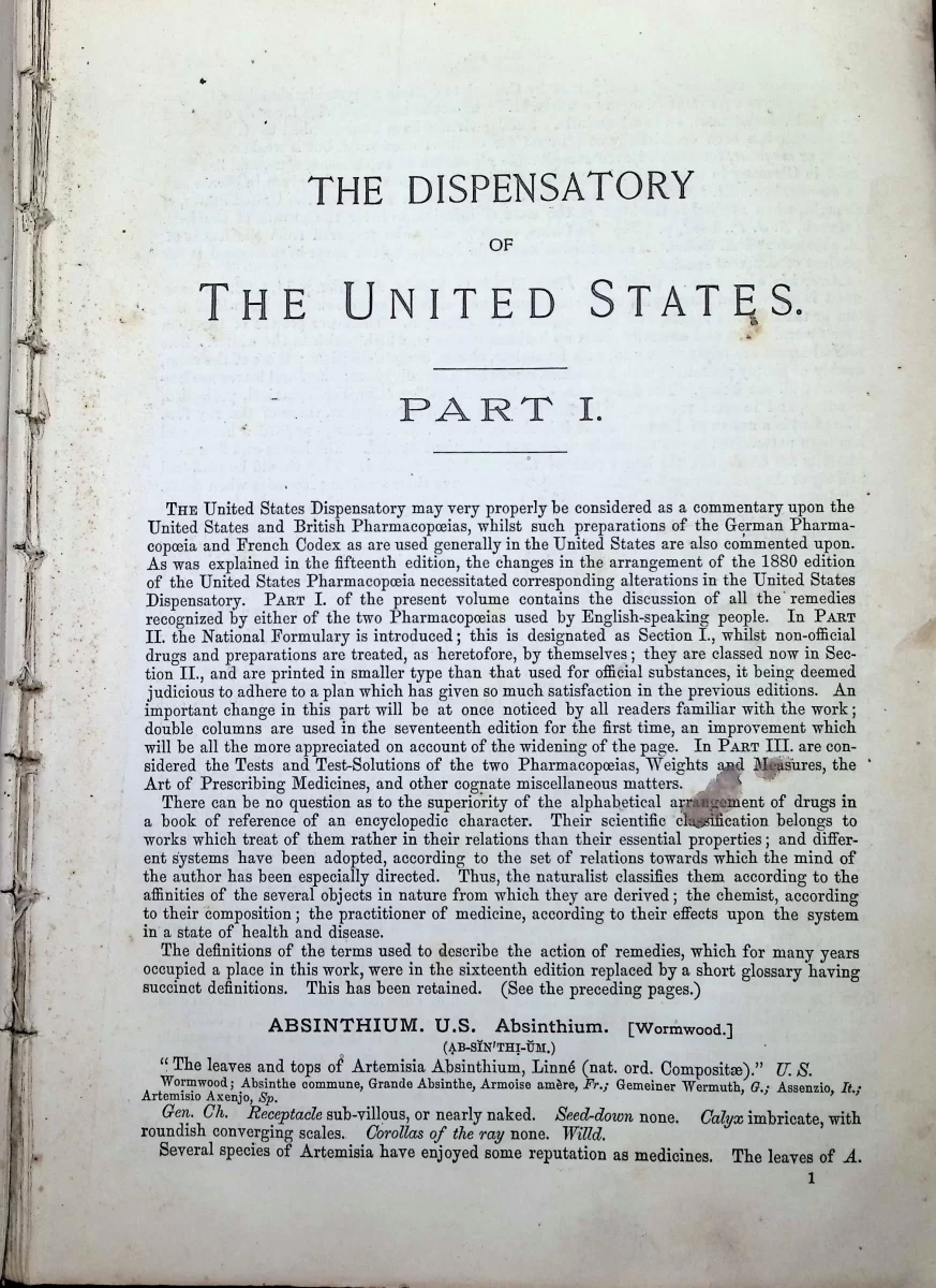 Antique medical book titled The Dispensatory of the United States of America, 17th edition, open to interior pages showing drug entries and National Formulary section.