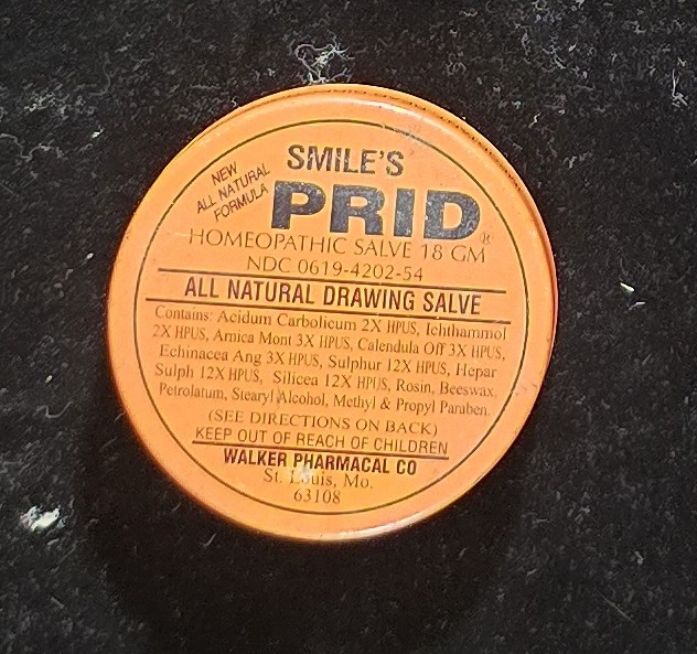Top of Smile’s PRID drawing salve tin showing label and ingredients