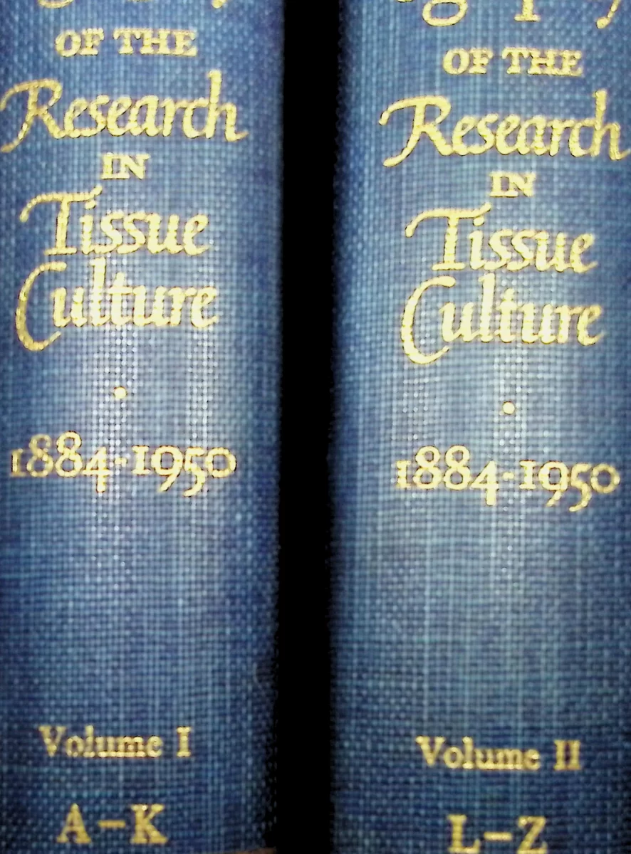 Spines of two blue volumes titled A Bibliography of the Research in Tissue Culture, 1884–1950