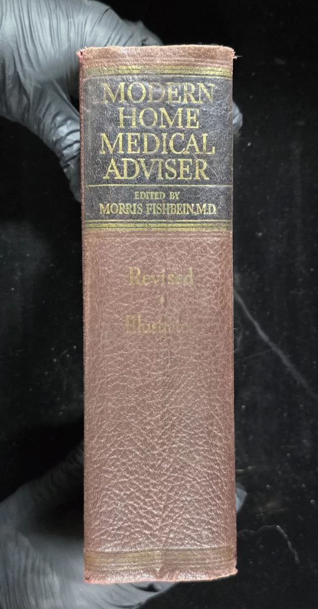 Modern Home Medical Adviser (1943) by Morris Fishbein – brown textured cover with caduceus emboss.