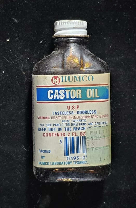 Vintage Humco Castor Oil bottle, 2 fluid ounces, labeled tasteless and odorless cathartic, manufactured in Texarkana, Texas.
