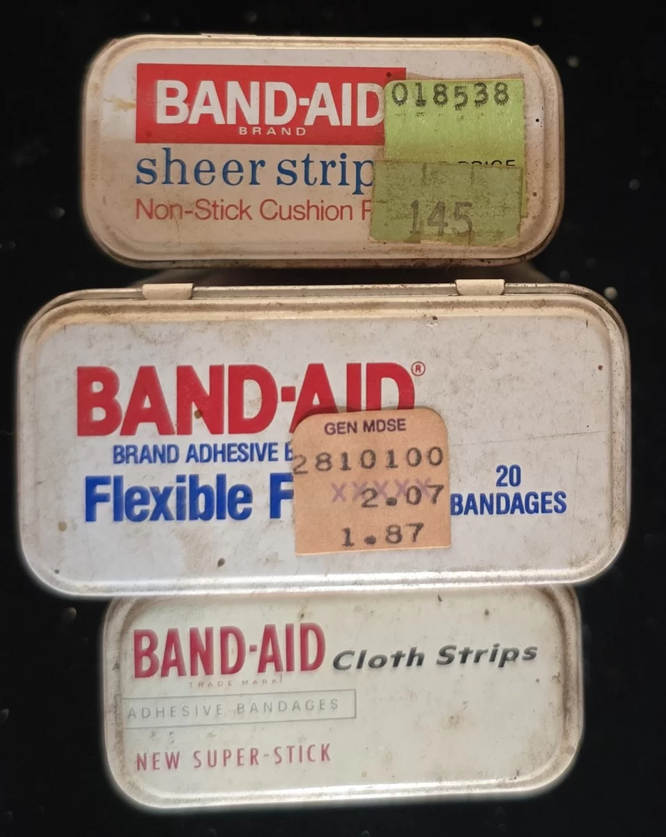 Top view of three vintage Band-Aid tins showing product labels
