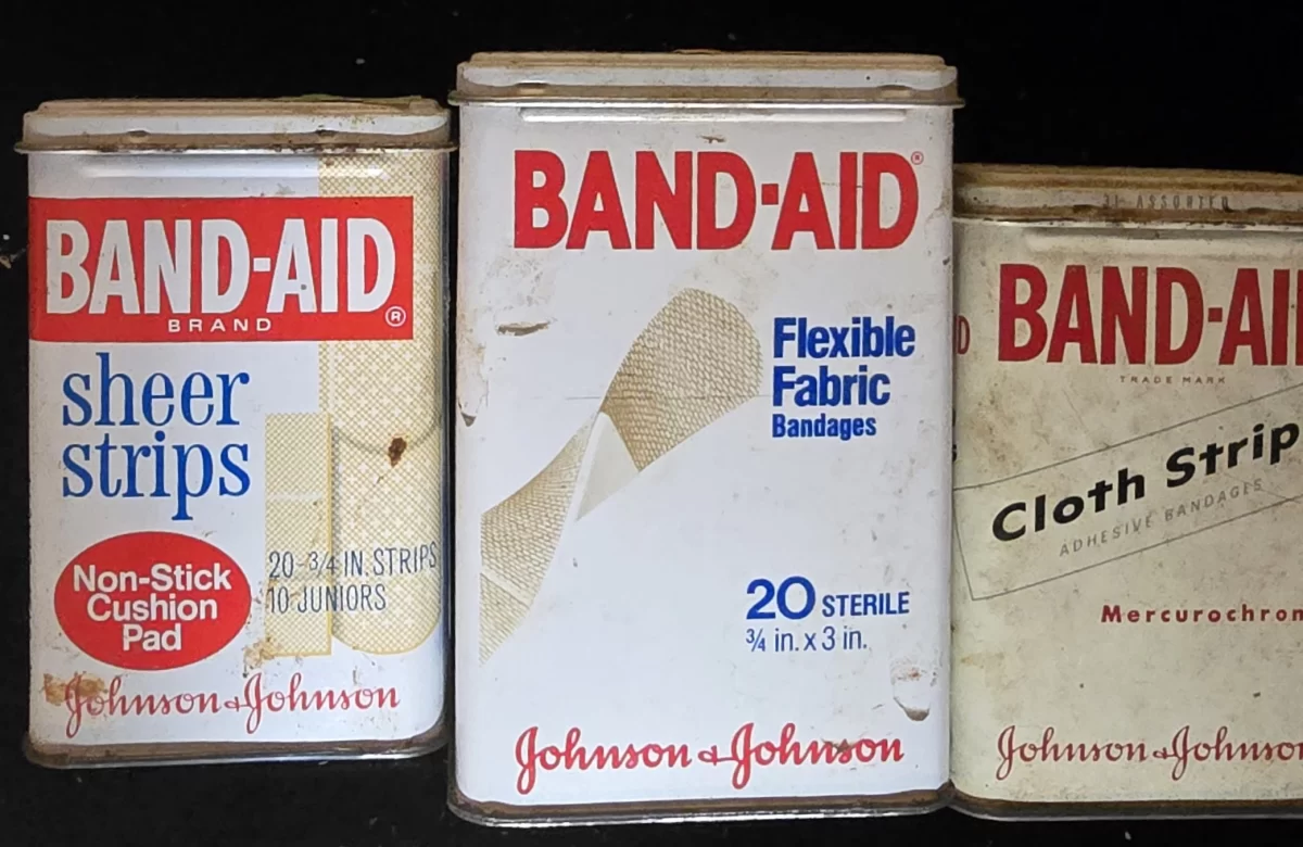Additional view of three tins showing branding evolution