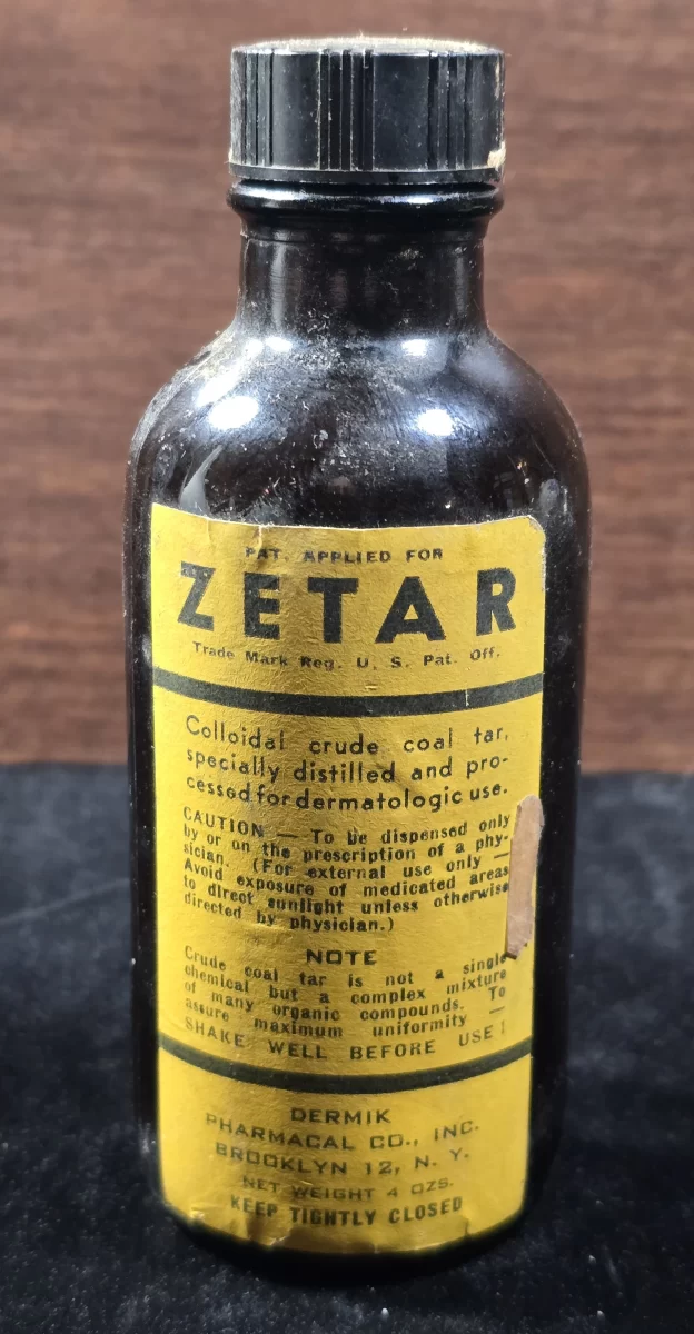 Vintage Zetar bottle labeled colloidal coal tar, produced by Dermik Pharmacal Co.