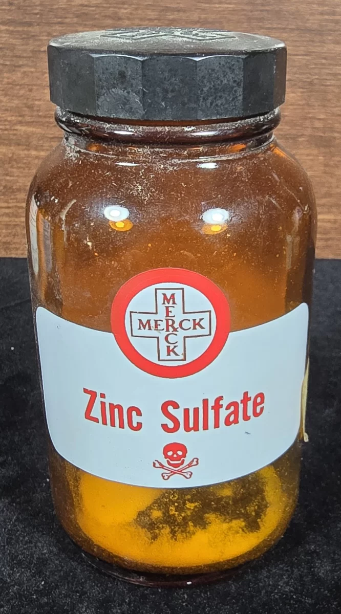 "Front view of vintage Merck zinc sulfate bottle with poison label"