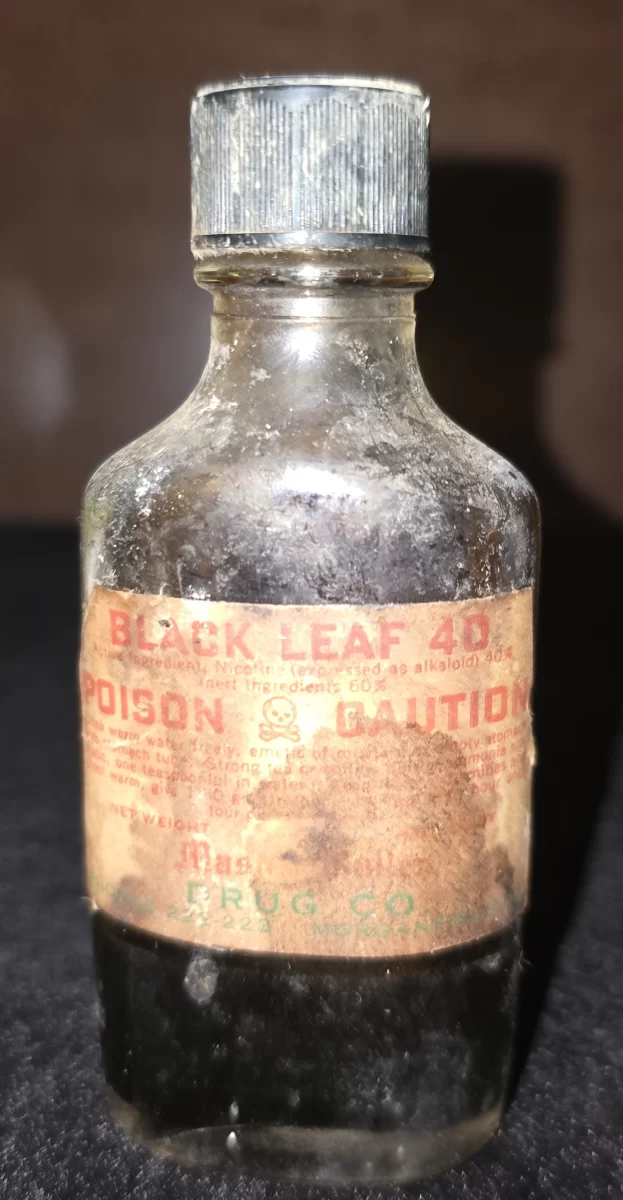 Amber bottle of Black Leaf 40 nicotine insecticide with poison warning label