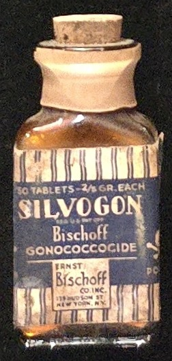 Antique brown glass bottle of Silvogon (Bischoff Gonococcocide), labeled as poison and marketed as a gonorrhea treatment, manufactured by Ernst Bischoff Co. New York, early 20th century.