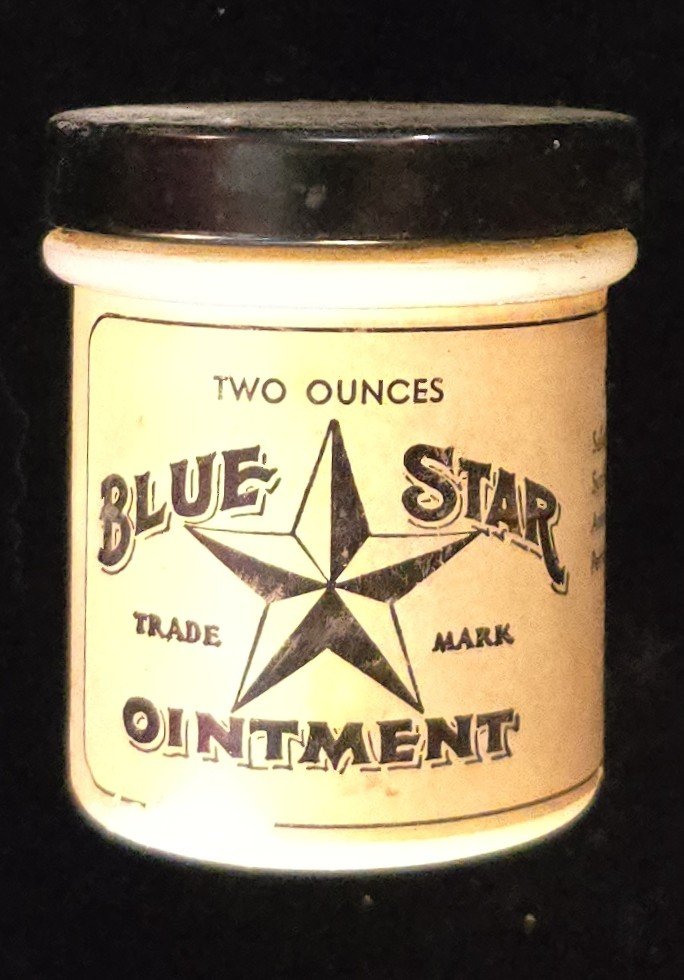 Vintage Blue Star Ointment jar with black lid, manufactured by Jim Bourland in Houston, Texas