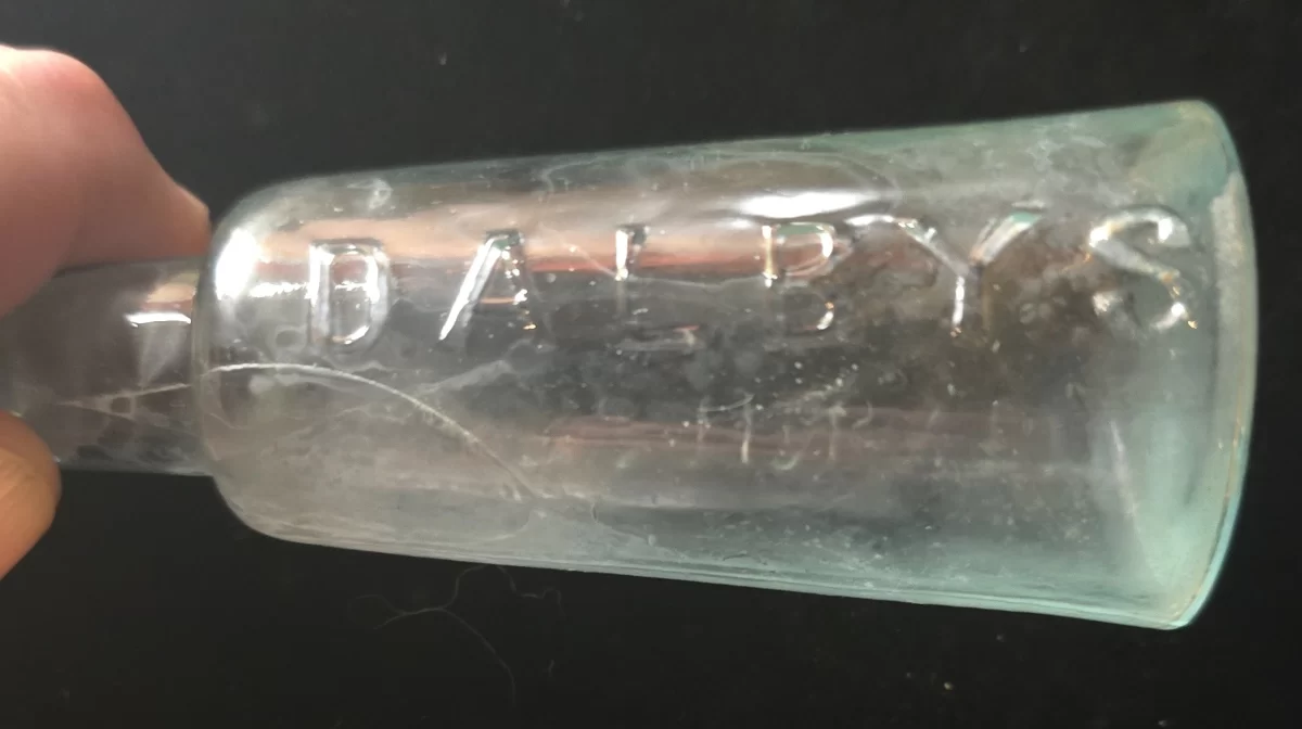 Embossed aqua glass Dalby’s Carminative medicine bottle