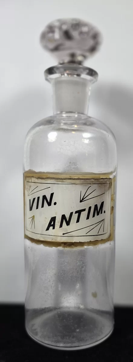 lear glass apothecary bottle with enameled label VIN. ANTIM. and ground glass stopper.