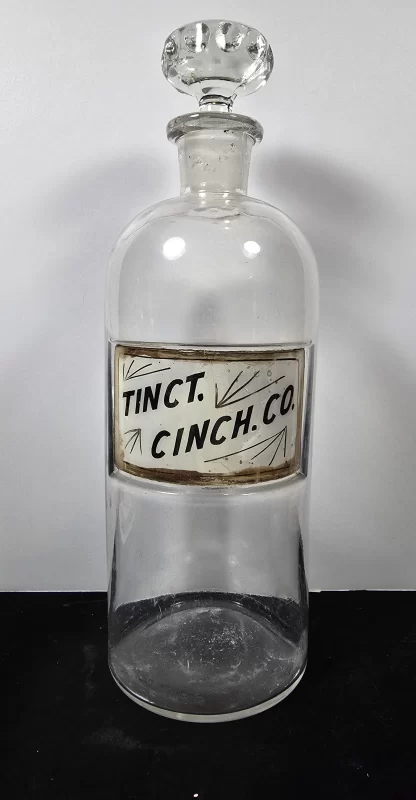 Antique apothecary bottle labeled Tinct. Cinch. Co. for Compound Tincture of Cinchona with glass stopper.