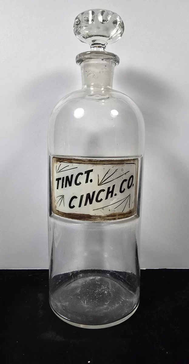 Antique apothecary bottle labeled Tinct. Cinch. Co. for Compound Tincture of Cinchona with glass stopper.