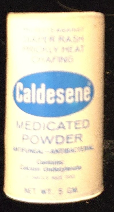 Vintage Caldesene Medicated Powder tin labeled “Antifungal–Antibacterial—Calcium Undecylenate.” Internal link targets: link to related topical or dermatologic products in the Cabinet (e.g., Desenex, Nupercainal).