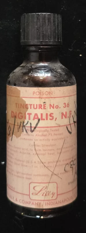 Amber glass bottle labeled “Tincture No. 36 Digitalis, N.F.” by Eli Lilly & Company, Indianapolis. Red “POISON” warning printed across the top label.