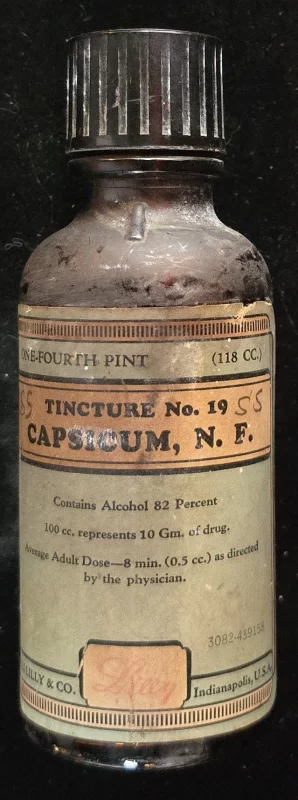 Amber Eli Lilly bottle labeled “Tincture No. 19 Capsicum N.F.” with black metal cap and aged paper label.
