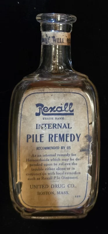 Clear labeled Rexall Internal Pile Remedy bottle from United Drug Co., Boston, marketed for hemorrhoids as an internal remedy to reduce swelling, bleeding, and irritation.