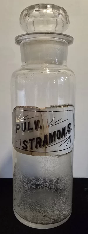 Antique apothecary jar labeled Pulv. Stramonii with glass stopper