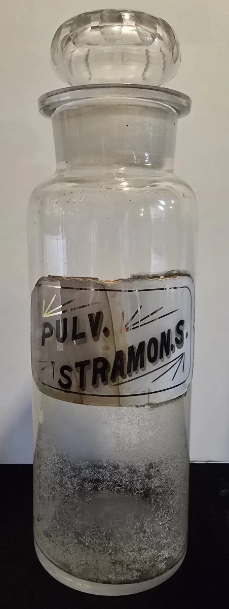 Antique apothecary jar labeled Pulv. Stramonii with glass stopper
