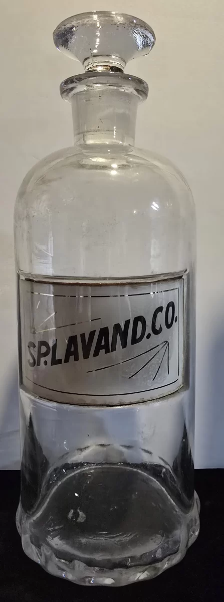 Antique apothecary jar labeled SP. LAVAND. CO. with glass stopper