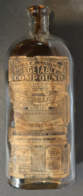 Antique Lydia E. Pinkham’s Vegetable Compound bottle with embossed lettering and partial label.