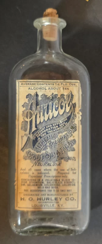 Vintage Auricol pain and gout remedy bottle from H.O. Hurley Co., Louisville, Kentucky, labeled for rheumatism, gout, sciatica, and neuralgia.