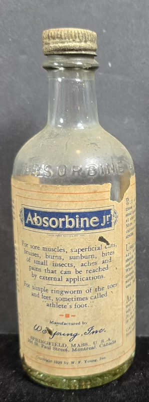 Absorbine Jr. embossed glass bottle with original paper label and metal cap, circa 1920s–1930s, Springfield Massachusetts.