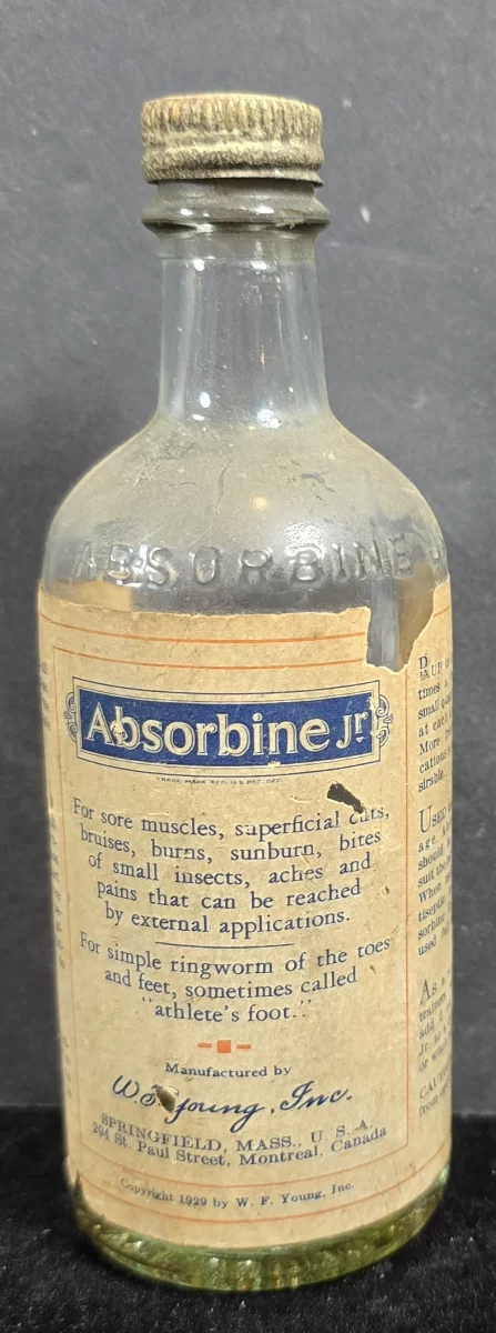 Absorbine Jr. embossed glass bottle with original paper label and metal cap, circa 1920s–1930s, Springfield Massachusetts.