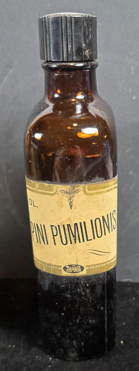 Amber Rexall bottle labeled Ol. Pini Pumilionis (Oil of Dwarf Pine), ca. 1930s–1950s, with Latin pharmacy label.