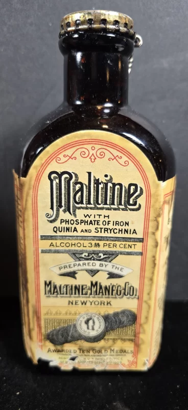 Amber bottle labeled Maltine with Phosphate of Iron, Quinia, and Strychnia, with hinged metal cap and gold medal label, ca. 1905–1915.