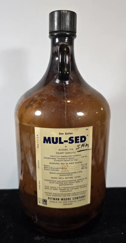 One-gallon amber glass bottle of MUL-SED exempt narcotic by Pitman-Moore, with intact vintage label.