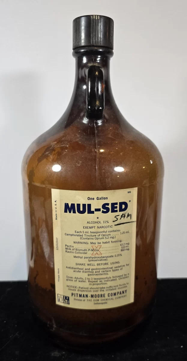 One-gallon amber glass bottle of MUL-SED exempt narcotic by Pitman-Moore, with intact vintage label.