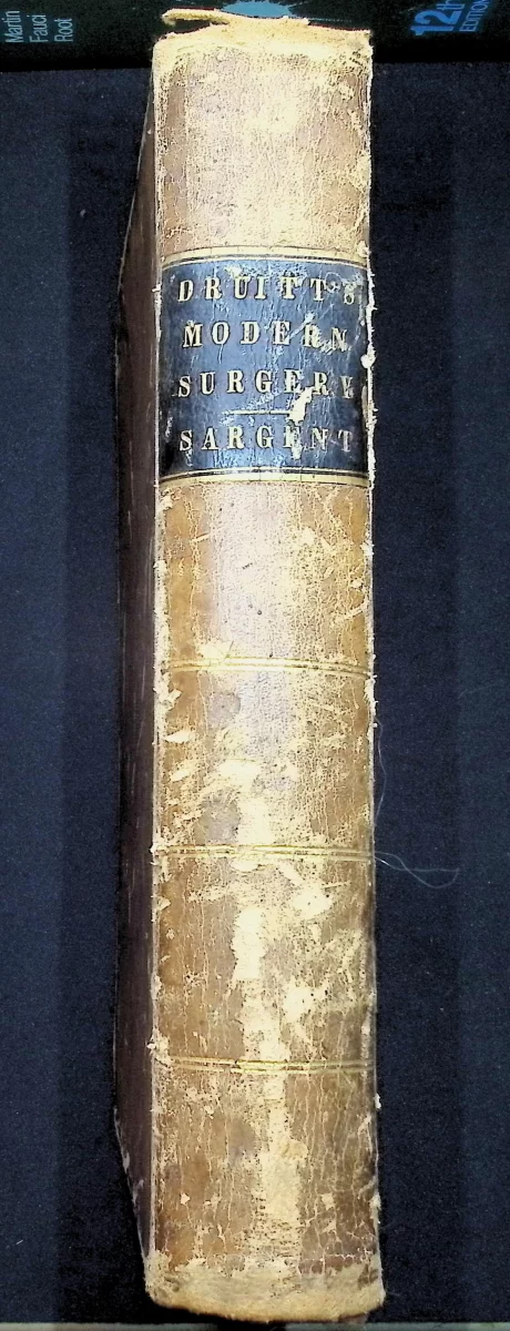1853 leather-bound edition of Druitt’s The Principles and Practice of Modern Surgery with worn spine and title page.